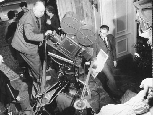 Jean Renoir (standing atop camera) on the set of French Cancan