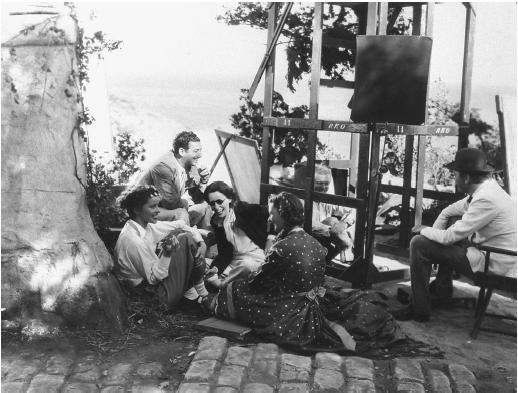 Mark Sandrich (sitting on ground by scaffolding), on the set of A Woman Rebels