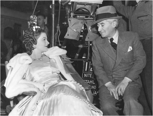 John M. Stahl and Myrna Loy on the set of Parnell
